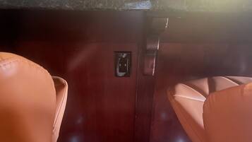 A dark wooden counter with a power outlet and a small control panel.