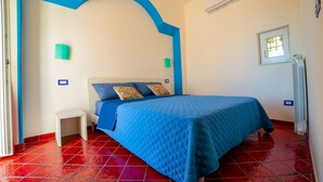 A bedroom with a bed, a nightstand, a window, and a radiator. - Independent house with access to a panoramic lemon grove on the Amalfi Coast! (Scala)