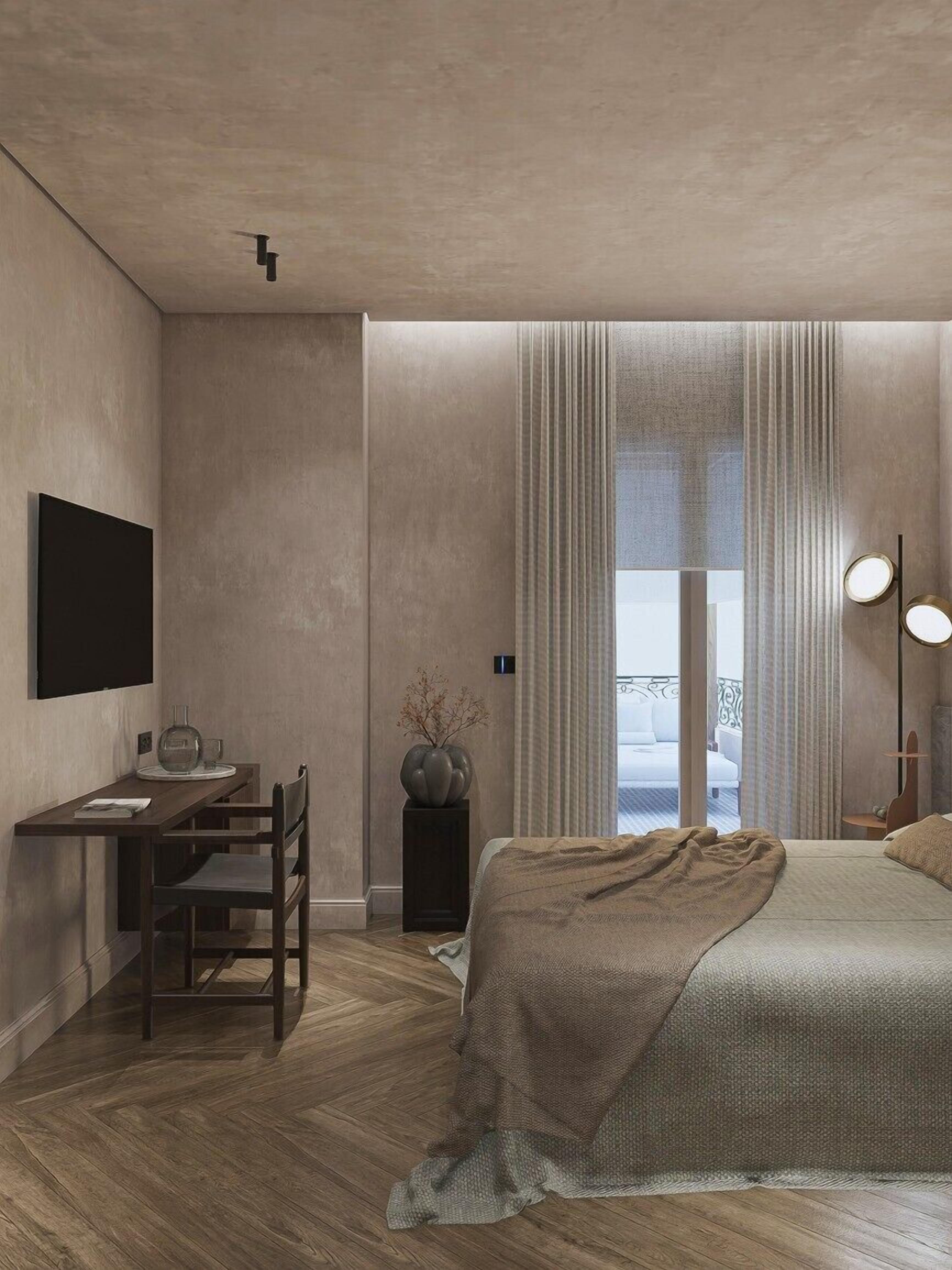 A modern bedroom with a bed, a desk, and a chair.