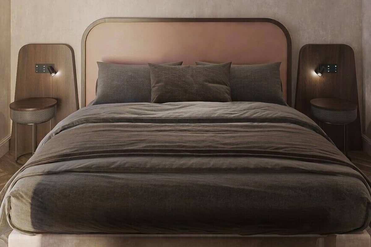 A modern bedroom with a large bed, two nightstands, and a ceiling light fixture.