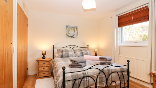 A bedroom with a bed, bedside tables, a window with blinds, a radiator, and a door labeled "PRIVATE". - 10 Annesley Park (Banchory)