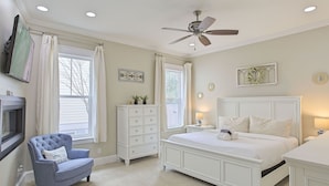 A bedroom with a large bed, a chair, a dresser, and a ceiling fan. - Aqua Waters - Newly Updated Vacation Home with Golf Cart, Private Pool + Cabana! (Destin)