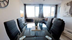 A modern conference room with a glass table, black leather chairs, and a sofa. - Interchange14 - NEC Airport Interchange (Birmingham)