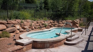 Relax by the pool surrounded by a natural landscape and lush greenery.