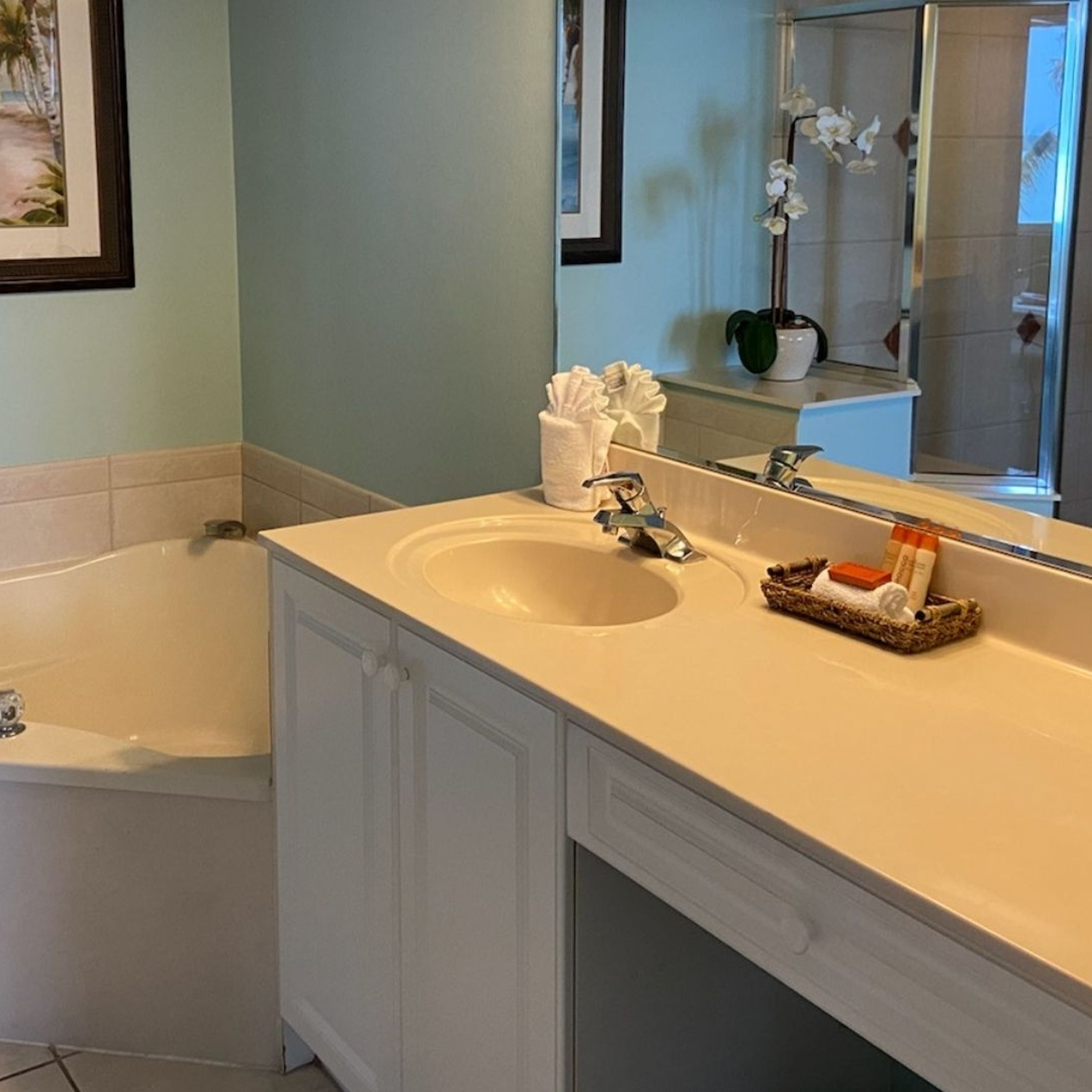 A bathroom with a bathtub, a sink, and a mirror.