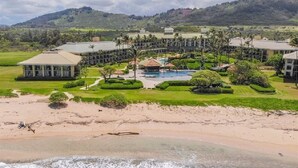 A resort with multiple buildings, a central pool, and a beach area. - Oceanfront Resort steps to pool/beach via your lanai, 4 Beautiful Pools (Lihue)