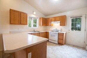 Enjoy cooking in this well-lit kitchen with a gas stove and ample cabinetry.