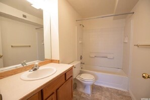 Enjoy a refreshing shower or soak in the bathtub in this well-appointed bathroom.