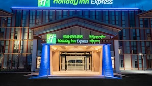 A Holiday Inn Express building with a prominent sign, large entrance, and a modern architectural design. - Holiday Inn Express Linzhi Airport by IHG (Nyingtri)