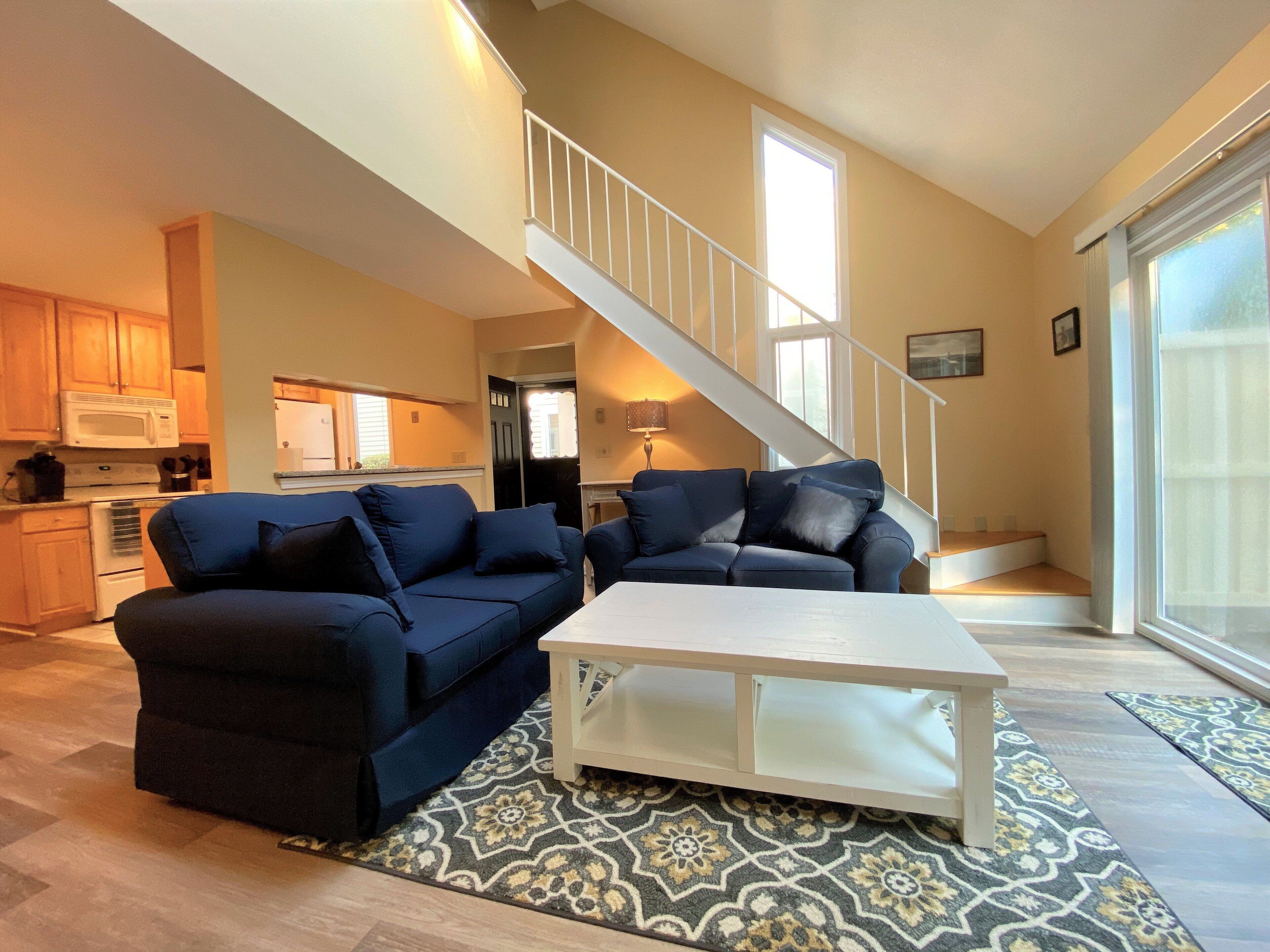 Spacious, renovated townhouse beautifully decorated with nautical décor with a straight staircase.