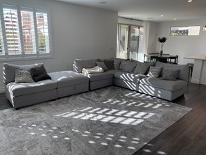 Relax in this inviting living room with a comfortable sofa and dining area.