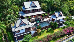 A large, multi-story resort with a swimming pool, lush gardens, and a tropical setting. - Nakawanna Villa (Kamala)