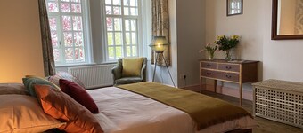 Large beautiful unusual house with lots of character and art on the walls.