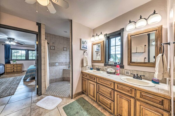 A bathroom with wooden cabinets, a double sink, and a large mirror. - Hot Tub & Mtn Views! 'Casa Ruidoso' Cabin (Alto)