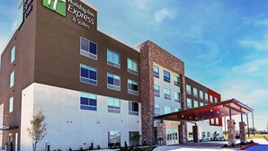 A Holiday Inn Express building with a modern design, featuring multiple windows and a covered entrance. - Holiday Inn Express & Suites Houston SW - Rosenberg by IHG (Richmond)