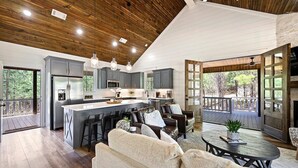 A spacious kitchen with a central island, grey cabinets, and a wooden ceiling. - Platinum Ridge - Luxury One Bedroom with Bunk Nook (Broken Bow)