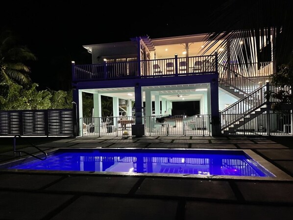 A two-story building with a pool in front.