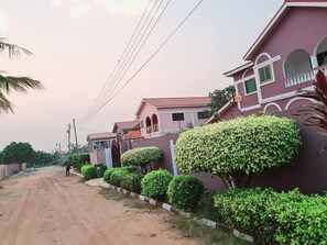 Stroll down this charming residential street lined with pastel-colored houses and lush greenery.