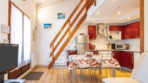 A modern apartment with a dining area, kitchen, and living room. - Le Hameau du Rivage by Interhome (Saint Cyprien)