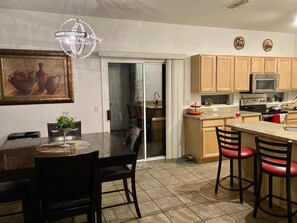 Enjoy meals in the dining area with a table and chairs, or cook up a storm on the kitchen island with stools.