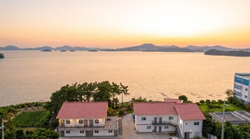 Una propiedad costera con vista al mar y montañas a lo lejos.