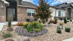 A residential house with a landscaped garden featuring various plants and a stone pathway. - Family-Friendly Grand Junction House w/ Patio (Grand Junction)