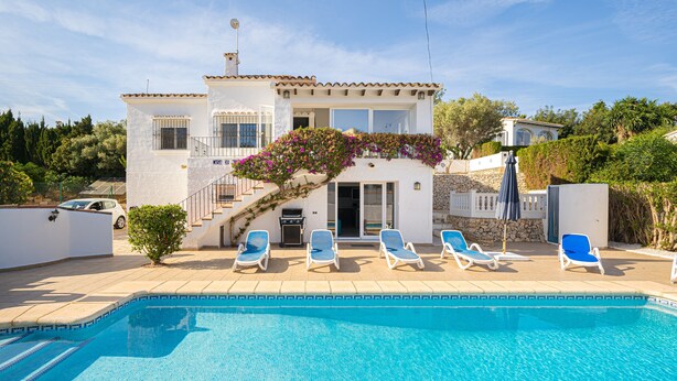 A poolside view of a house with a pool, lounge chairs, and a staircase leading to the entrance. - Casa De Mi Padre, La Fustera with Sea View, Wi-Fi and Air Conditioning (Benisa)