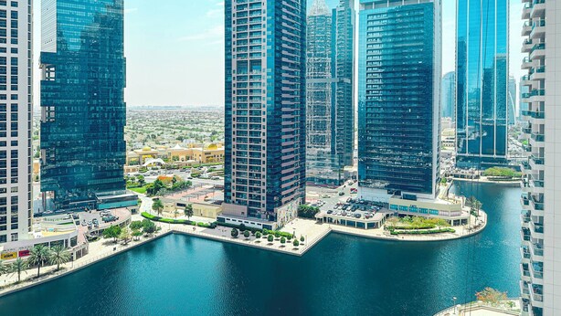 A high-rise urban area with modern buildings, a waterfront, and a marina. - Lake View Brand New Studio in X1 Tower JLT - LND (Dubai)