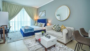 A modern hotel room with a bed, a sofa, a desk, and a dining area. - Lake View Brand New Studio in X1 Tower JLT - LND (Dubai)
