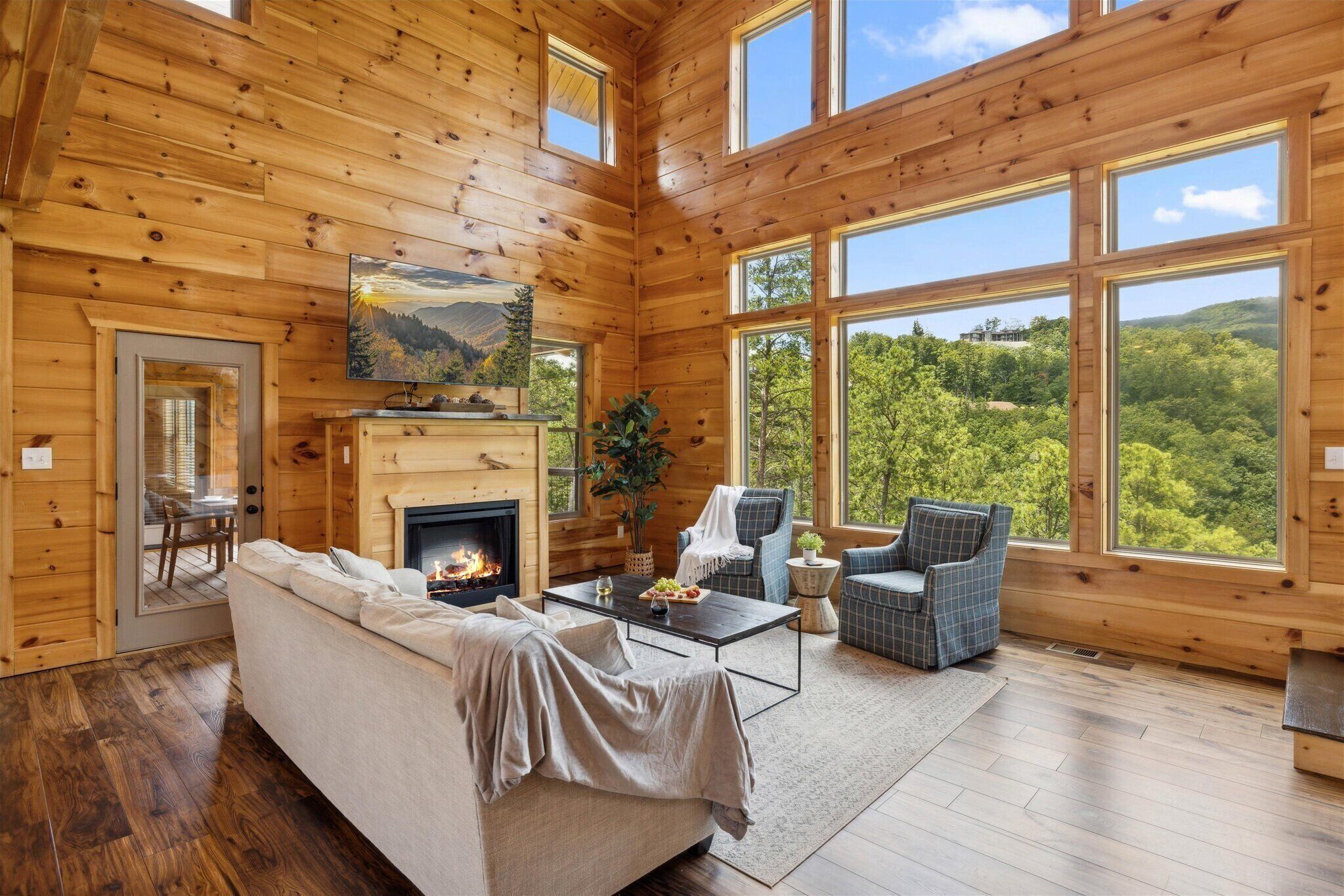 Cozy up in front of the large fireplace for a family movie night on our 70" Smart TV | Big Pine Chalet | | Great Smoky Mountain Cabin Rentals |  Gatlinburg Cabin Rentals | Pigeon Forge Cabin Rentals |