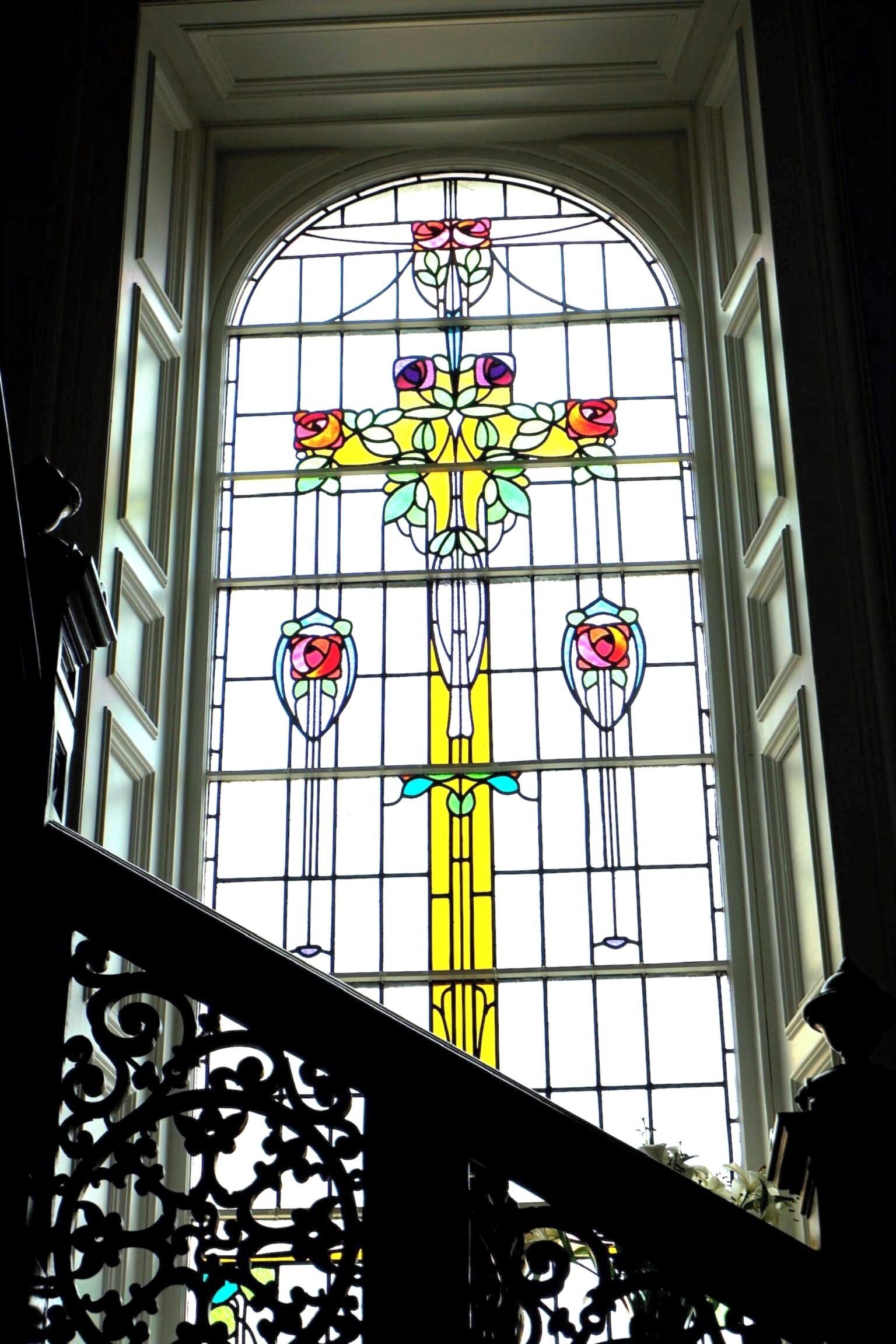 A stained glass window with floral designs.