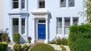 A two-story building with a blue door and a sign reading "The Clarendon." - The Clarendon (Dundee)