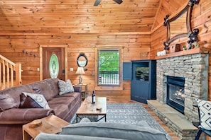 Relax by the fireplace in this inviting living room with a leather sofa and coffee table.
