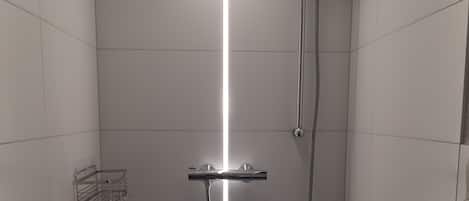 Shower, hair dryer, towels, toilet paper