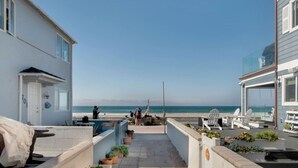 A coastal property with a patio, potted plants, and a view of the ocean. - Ben`s Beach Bungalow 3, Ocean View Mission Beach 1 (San Diego)