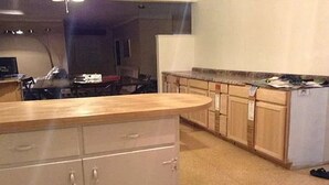 A kitchen with wooden cabinets, a countertop, and a refrigerator. - Single family home+ large rooms +kitchen + living room+den roo + beautiful  yard (Catonsville)
