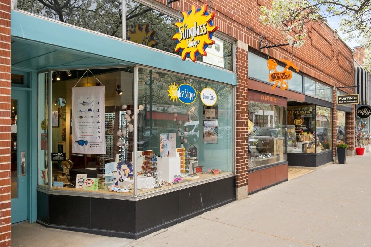 A storefront with a clear glass window displaying various items.
