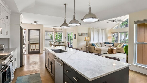 A modern kitchen with a large island, built-in appliances, and pendant lighting. - **The Caddy's Shack** 1 story home with Club Cards Optional (Fripp Island)