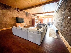 Relax in a spacious living area with a large sectional sofa and flat-screen TV.