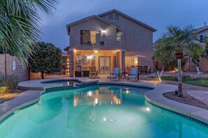 A two-story house with a swimming pool, outdoor seating, and a well-lit patio area. - Boulder MT Highlands: Near Golf & Trails, POOL w/Opt Heat, Spa, Putt Green, King Beds & TVs All BRs (Mesa)