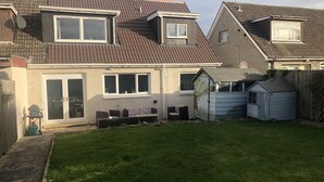 A residential house with a sloped roof, a fenced backyard, and a small shed. - St. Andrews House available for the Open (St Andrews)