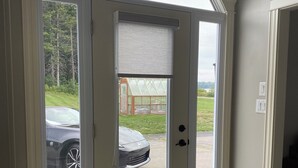 A room with a large sliding glass door leading to a covered outdoor area.