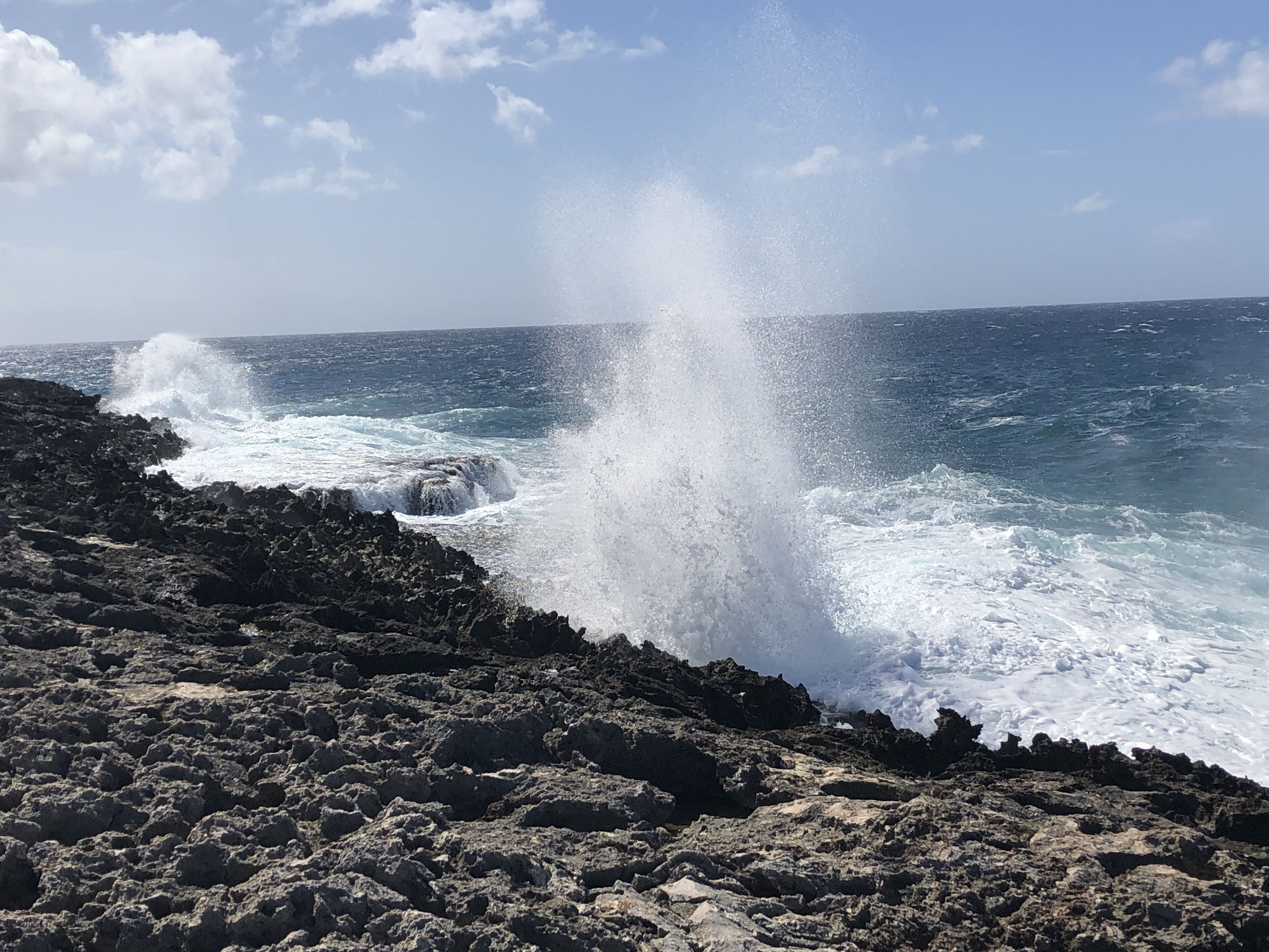 A rocky coastline with waves crashing against the rocks.