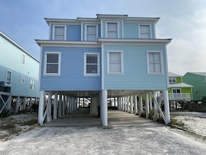 A two-story house with a covered walkway and a porch.