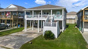 A two-story residential building with a balcony and a covered porch area.
