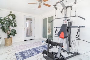 Bowflex home gym and space for yoga in the fitness room