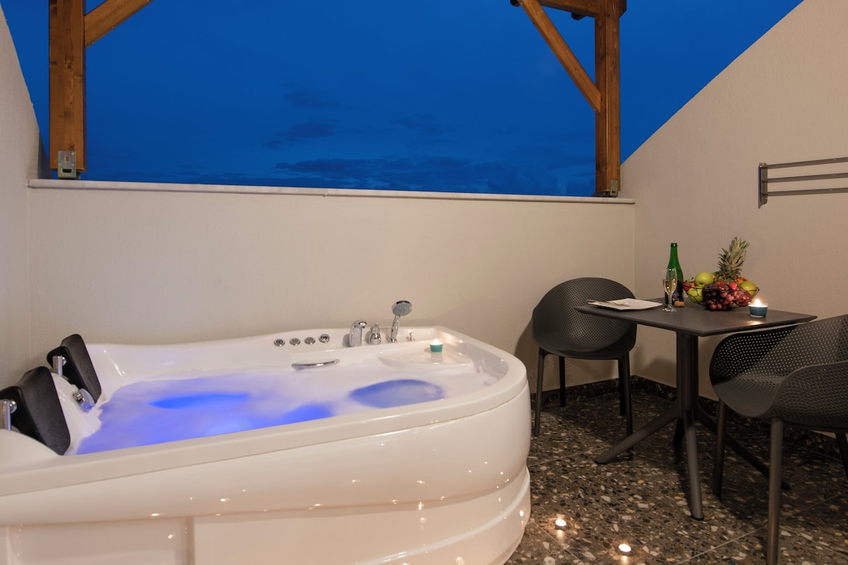 A hot tub under a wooden pergola with a view of the sky.