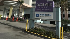 A hotel entrance with a sign for Ocean Walk Resort, Wyndham Vacation Ownership, and a building with multiple floors and balconies. - Wyndham Ocean Walk 2BR (Daytona Beach)