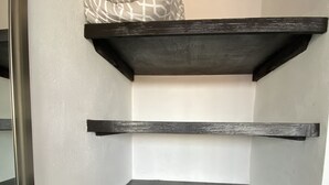 A corner of a room with three black shelves against a white wall. - Hotel Las Palmas Puerto Morelos (Puerto Morelos)