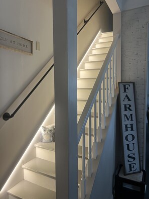 A staircase with a sign reading "FARMHOUSE" and another sign above it that says "SELF AT HOME". - Restored farmhouse just steps from the Katy Trail (Rhineland)